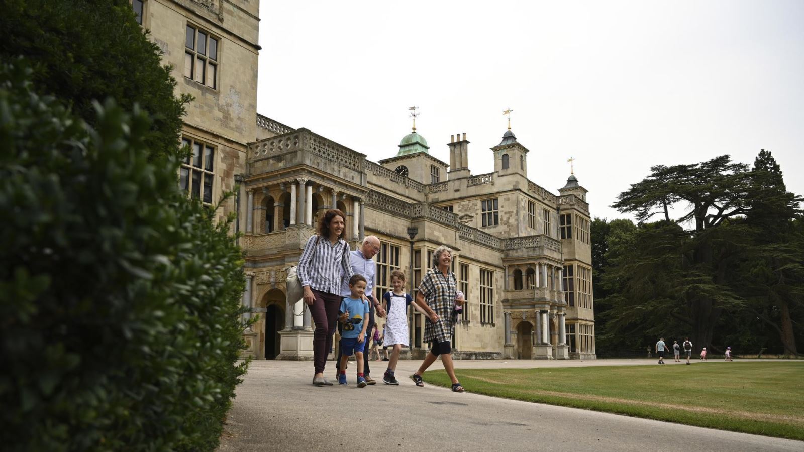 Family walking around the grounds of Audley End House & Gardens in Essex