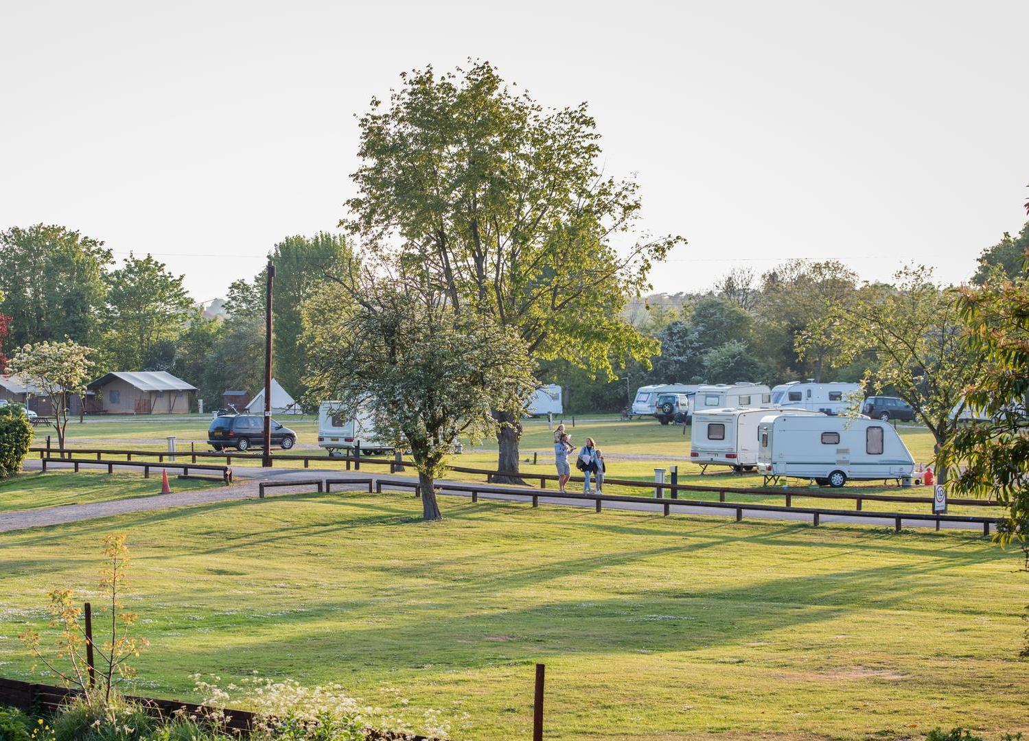 caravans and motorhomes in camping field at Lee Valley Caravan Park